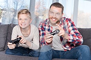 Father and son playing with joysticks