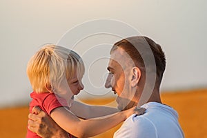 Father and son playing and laughing outdoors. Happy childhood and fatherhood