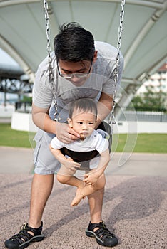 Father and son playing in outdoor park