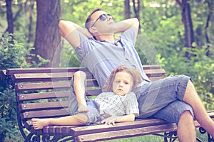 Father and son playing at the park on bench at the day time.