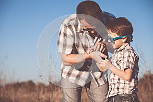 Father and son playing in the park at the day time