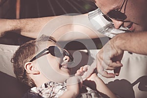 Father and son playing in the park at the day time