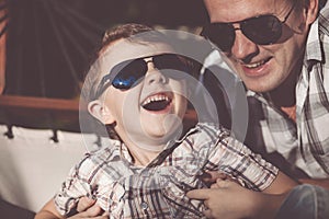 Father and son playing in the park at the day time