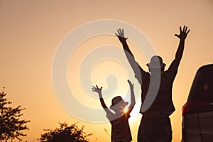 Father and son playing in the park at the sunset time