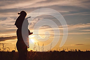 Father and son playing in the park at the sunset time