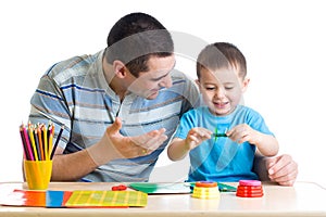 Father and son playing with plasticine