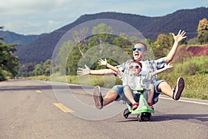 Father and son playing on the road.