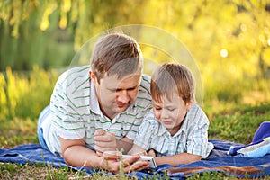 Father and son playing with smartphone