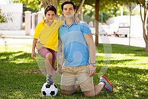 Father and son playing soccer