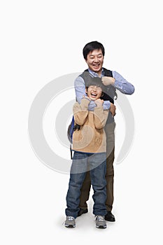 Father and son playing, studio shot