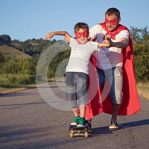 Father and son playing superhero at the day time