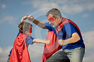 Father and son playing superhero at the day time