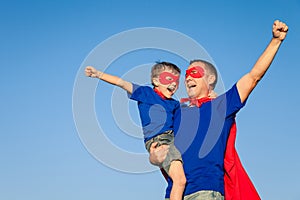 Father and son playing superhero at the day time.