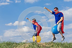 Father and son playing superhero at the day time.