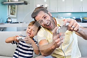 Father and son playing video games together