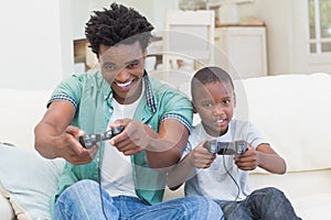 Father and son playing video games together