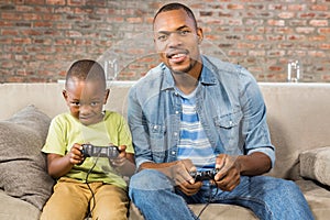 Father and son playing video games together