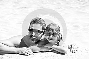 Father and son in pool. Vacation concept. Happy family in swimming pool. Pool party. Child with dad. Fathers Day.