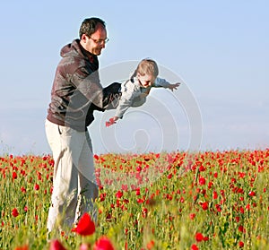 Father and son in poppy field