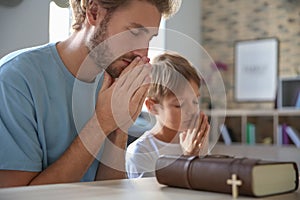 Father with son praying at home