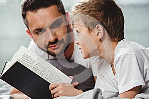 Father and son reading book