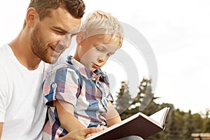 Father and son reading book