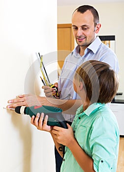 Father and son repairing house