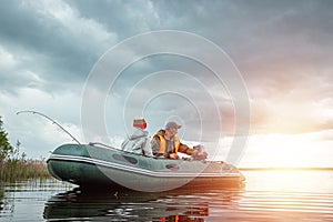 Father and son ride a motor boat on the lake. The concept of family, summer vacation, generation. Copy space