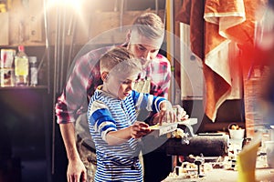 Father and son with ruler measure wood at workshop