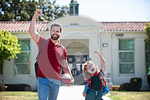 Father and son run with father after come back from school. School, family, education and outdoor concept, back to