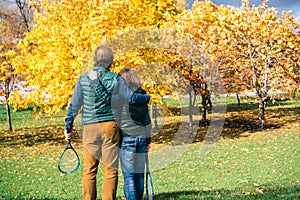 A father and son of school age with badminton racket are talking