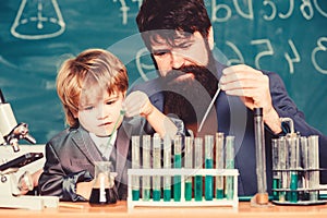 Father and son at school. biotechnoloy research concept. Back to school. Explaining biology to child. bearded man