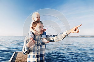 Father and son on sea and sky backgrounds.