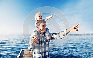 Father and son on sea and sky backgrounds.