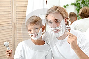 Father and son shaving together