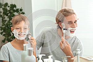 Father and son shaving together