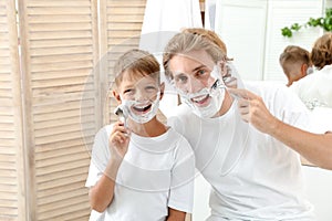 Father and son shaving together