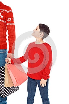 father and son with shopping bags holding hands,