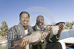 Father And Son Showing Freshly Caught Fish