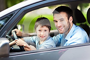 Father and son sitting in a car