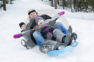 Father and son sledding at winter time photo