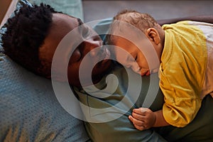 Father and son sleeping together at naptime