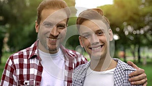 Father and son smiling and looking at camera, teeth health, dentalcare whitening photo