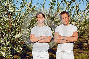 Father and son are smiling in nature.