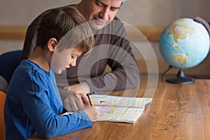 Father and son solving mathematics homework togehter