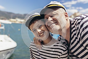 Father and son spending time at marina on summer day