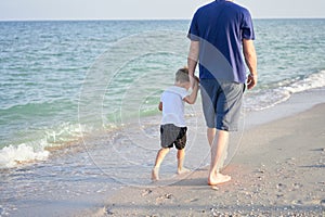 Father son spending time together sea vacation Young dad child little boy walking beach