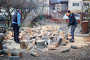 Father and son splitting wood