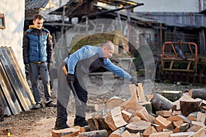 Father and son splitting wood