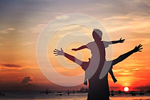 Father and son on sunset beach